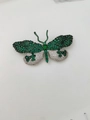 Macro shot of detailed green and white zircon butterfly brooch with dark metal base - Green And White Butterfly (02)