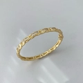 Elegant gold twisted bangle featuring square-cut clear cubic zirconia stones - Gold White Zircon