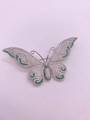 Close-up of pavé set white zircon and green gemstones on silver butterfly brooch - Silver Butterfly with Green Zirconia