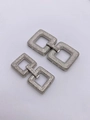 Detailed view of silver interlocking geometric clasps paved with sparkling zircons - Small / White