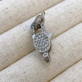 Silver lobster clasp pendant with micro-paved zircons on a beige jewelry tray - k2 Style / White Gold