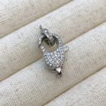 Silver lobster clasp with micro-paved white zircons on a beige jewelry stand - J1 Style / White Gold