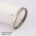 Detailed view of 7mm silver elastic stainless steel bracelet on a display stand - Silver Minimalist Bold Style (Style 47)