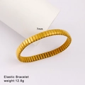 Detail of 7mm gold elastic stainless steel bracelet weighing 12.8g on white display - 7mm Width / Gold (Style 100)