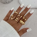 Close-up of a five-piece set of gold organic fluid rings on a model's hand - Minimalist Streamline Gold Style (6373)