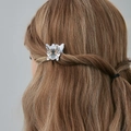 Detail view of a Halloween spider hair claw clip worn on hair with black and orange pattern - Spider Design (0666)