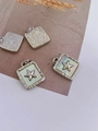 Detailed macro view of square shell pendants featuring 3D star motifs and metal relief - Star - Silver (Pendant Only (Without Chain))