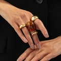 Chic 4-piece gold metal ring set with one amber resin band worn on a model hand - Multicolor Style (6909)
