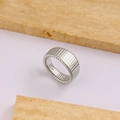 Sleek silver stainless steel textured ring with vertical grooves on a pink background - Size 5 / Steel