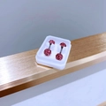 Close-up of sparkling pink crystal ball stud earrings in a white jewelry display box - 5mm Rose Pink Zirconia