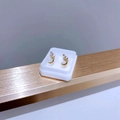 Detailed shot of gold-plated star and moon stud earrings with sparkling cubic zirconia - Gold Star and Moon