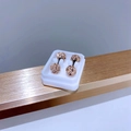 Macro shot of rose gold titanium screw back stud earrings with full white rhinestones - 6mm Champagne Zirconia