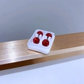 Close-up of red rhinestone ball earrings with silver studs in a white storage case - 6mm Red