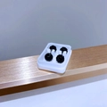 Close-up of four black faceted ball stud earrings set on a white display stand - 6mm Royal Blue Zirconia