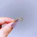 Detail of a thin gold ring with a hollow circle centerpiece and sparkling zircon stones - Gold Small Circle Style