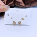 Drei Paar elegante goldene Ohrstecker mit Sternen und Zirkonia auf Seidenstoff - Pentagramm und Stern Buchstabe Stil (A04)