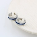 Detail of silver twisted rope C-shaped earrings with blue zircon stones in macro view - Silver Tone Royal Blue Rhinestone (CK359)