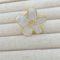 Macro shot of camellia flower ring with ivory petals, gold edges, and marble texture - White