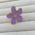 Detail of a purple camellia flower ring with golden edges on a jewelry tray - Purple