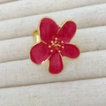 Macro detail of red enamel camellia flower ring with polished golden metal finish - Red