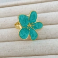 Close-up of golden camellia ring with teal enamel petals and marble texture detail - Light Green