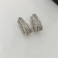 Dettaglio macro di orecchini a cerchio ovali argentati con pavé di zirconi bianchi - Stile Pavé Ovale 02 / Argento