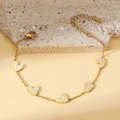 Elegant gold-plated stainless steel bracelet featuring five white enamel heart pendants - Yellow V-Pattern Heart Bracelet (TT0469)