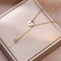 Chic gold heart lock and key Y-necklace featuring white mother of pearl inlay and floral key - Gold