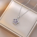 Detailed view of rotating purple zircon flower pendant on silver chain in a jewelry box - Silver Purple Floral Style (X0600) / Silver