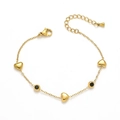 Detailed view of titanium gold chain with heart charms and black stone inlays - Black Gemstone Heart Bracelet (TT0467)