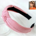 Detailed view of a pink knitted cross-knot headband with soft fabric texture and non-slip lining - Pink