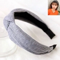 Detail of grey knitted twist knot headband showing textured fabric on a female model - Light Gray