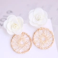 Detail of flower dreamcatcher earrings with white fabric roses and golden metal circles - White