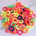 Colorful high-elastic seamless hair ties set on a white marble background texture - Fluorescent Multi-color
