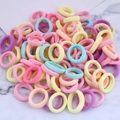Macro shot of colorful seamless elastic hair ties set in macaron shades on marble - Macaron Multicolor