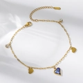 Detailed macro of gold titanium steel chain featuring blue heart crystal and charms - Blue Heart Style (TT1058)