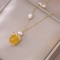 Elegant gold titanium necklace with baroque pearls and yellow oval stone on jewelry box - Necklace (X0634) / Yellow
