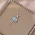 Detail of silver rose pendant with blue frosted resin bud and pavé set cubic zirconia - Light Blue