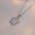 Detailed close-up of a silver turtle pendant encrusted with white pave zircons on silk - Turtle Necklace / Steel