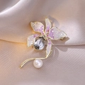 Macro shot of elegant flower brooch with pink zircons, gray crystal and a white pearl - Pink And White Gradient Flower Style (2)