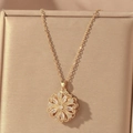 Close-up of golden hollow flower pendant necklace with white crystals on gold silk - Gold Double Layer Hollow Flower Style (X0600)