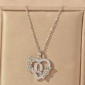 Detail of silver heart pendant featuring letter Q with green and white cubic zirconia - Hollow Heart Letter Q Necklace / Silver