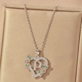 Detail of silver heart pendant with letter P, green stones and sparkling cubic zirconia - Hollow Heart Letter P Necklace / Silver