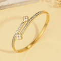 Elegant gold titanium steel bangle featuring white clover motifs and shimmering crystals - Clover Style (TT0932 Four-leaf Flower-3) / Gold