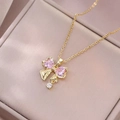 Golden bow necklace with pink heart-shaped zircons on a luxury jewelry box - Gold Heart Pink Gemstone Bowknot Style (X2944)