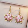 Rotating pink zircon flower necklace with golden petals and sparkly diamond center detail - Pink Rotating Flower (Earrings) / Pink