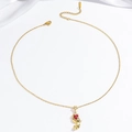 Elegant gold necklace featuring a star-shaped pendant with a red heart-shaped gemstone - Red Tulip Necklace (X1500)