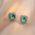 Square green zircon stud earrings with silver finish on champagne silk backdrop - Emerald Green Earrings (E609)