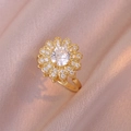 Gold sunflower ring with spinning petals and micro-pave crystals on pink satin - Sunflower Rotating Ring (J0346)