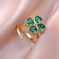Gold open ring featuring a green zircon clover and a white heart-shaped crystal - Emerald Green Rotating Ring